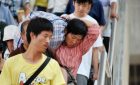 Passengers walk down stairs to board trains at Yinchuan Railway station.